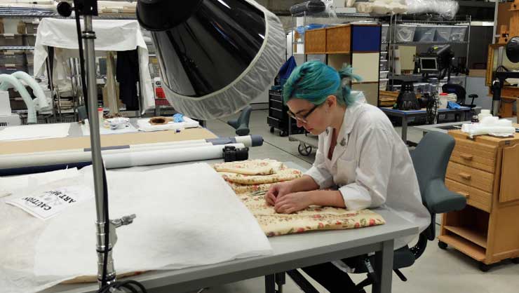 Francisca working with textiles at the Denver Art Museum
Image Courtesy of Francisca Lucero Juez