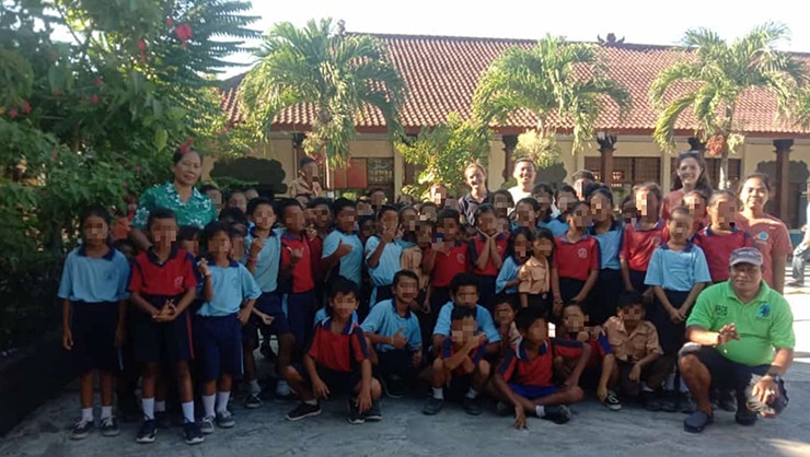 The Trash Team poses with students at SDN4.