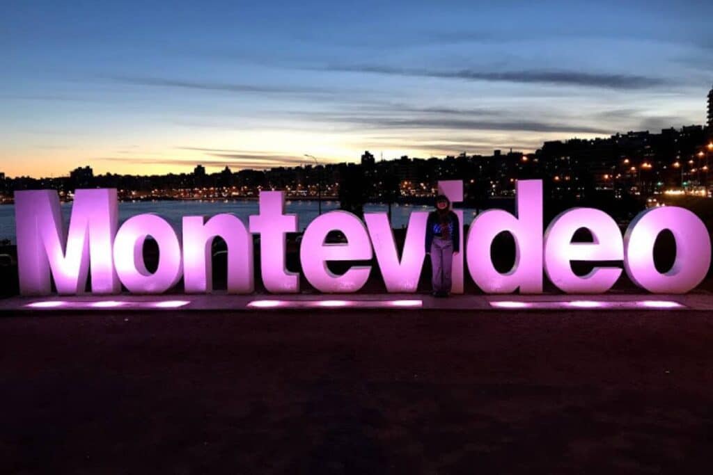 Standing in front of the Montevideo sign.