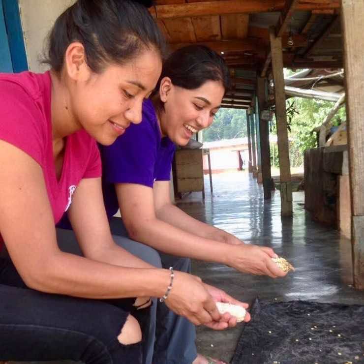 Cutting kernels off corn with a Community Healthcare Worker