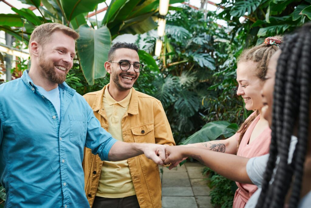 Diverse group of friends doing a fist bump.