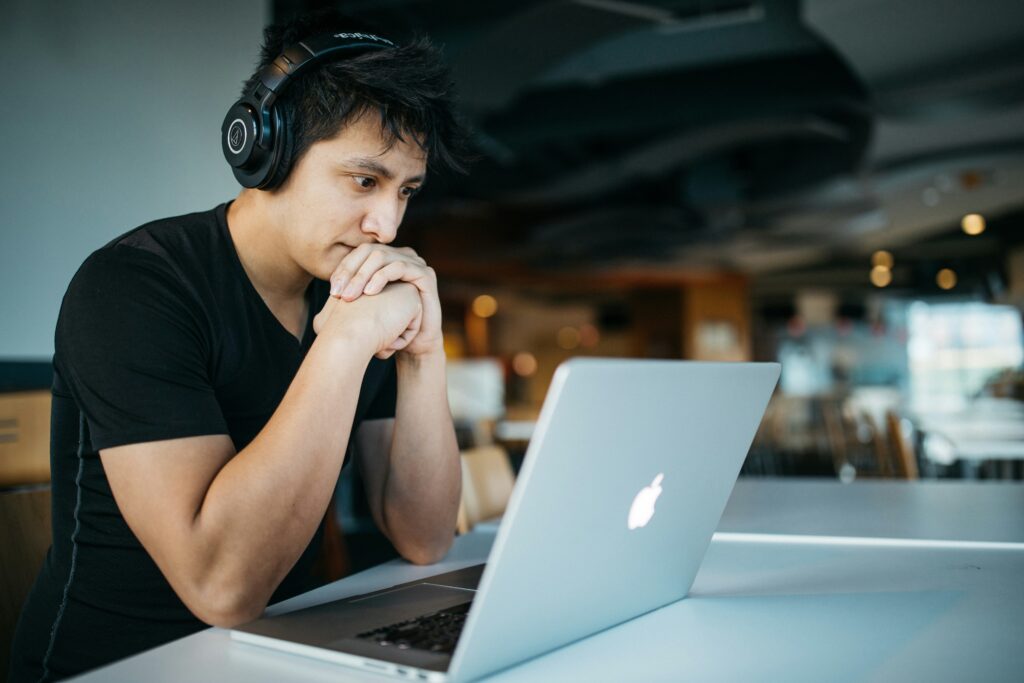 Man looking thoughtfully at a computer.