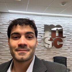 Male trainee posing in suit at corporate event.